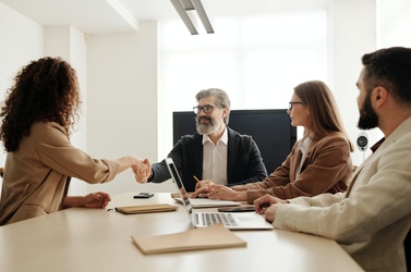 people conversing at desk 