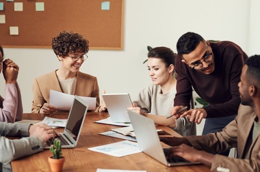 employees chatting over desk 